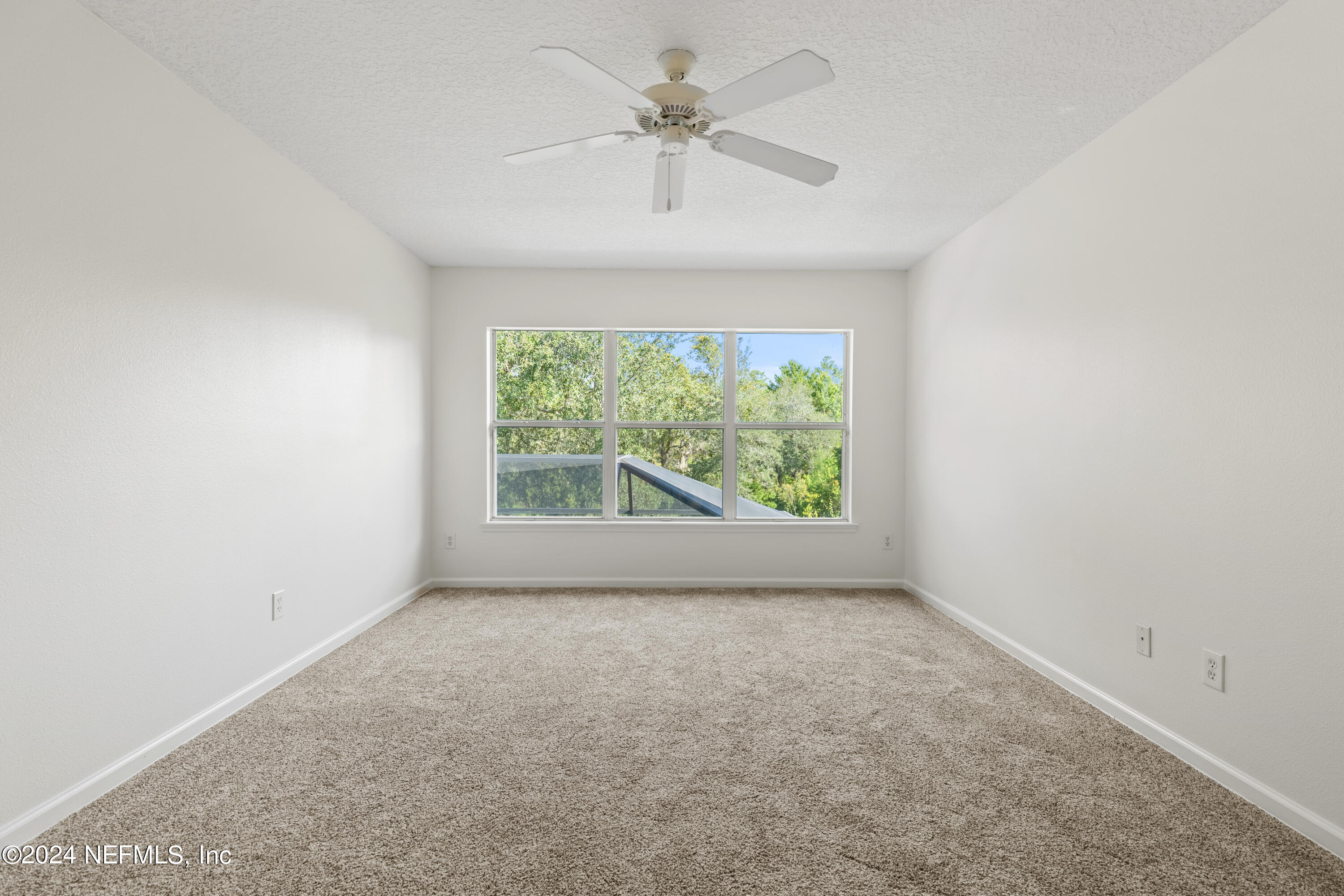 156 Bilbao Drive St. Augustine, FL 32086 - Photo 38 of 57 an empty room with a window and a fan