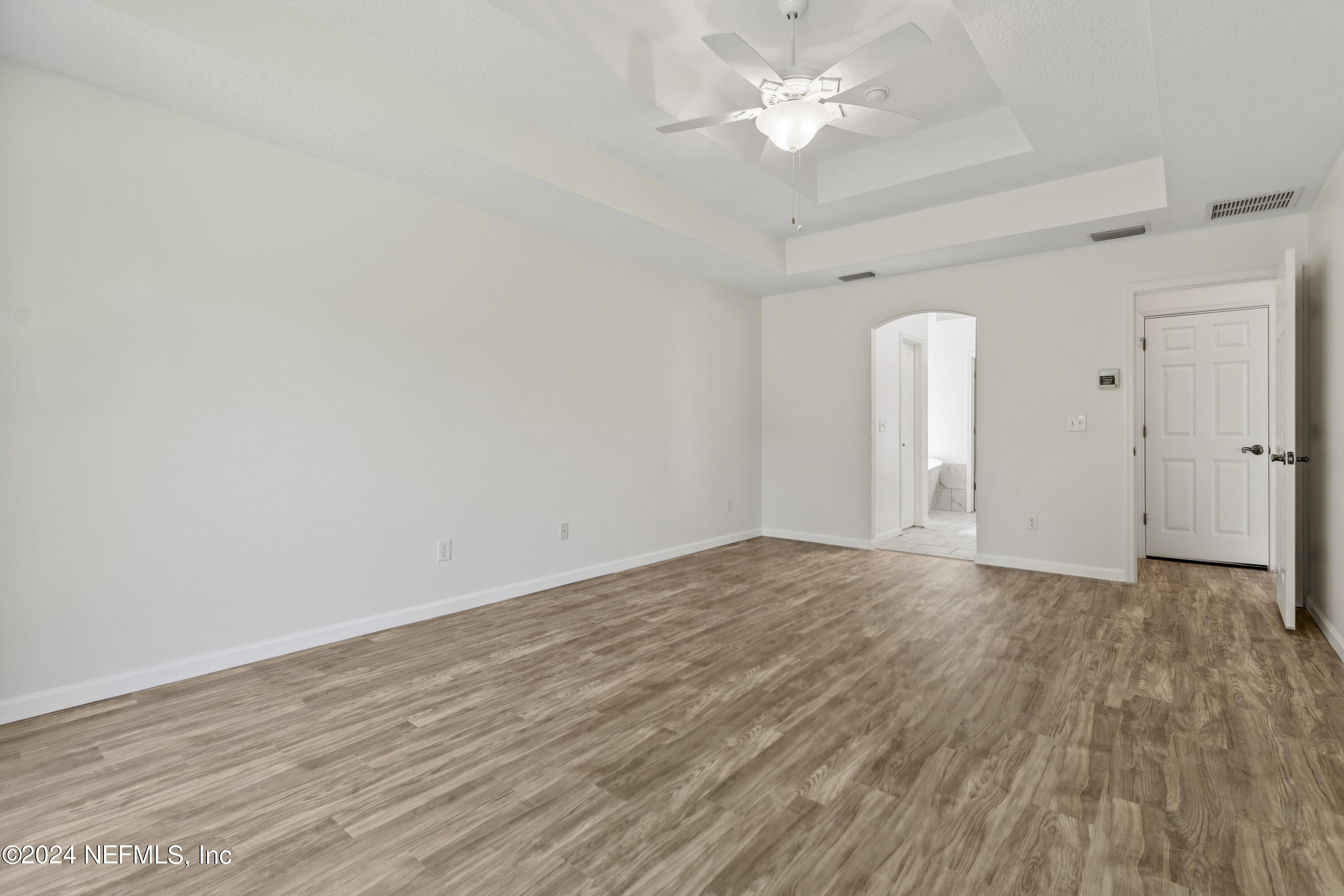 156 Bilbao Drive St. Augustine, FL 32086 - Photo 42 of 57 an empty room with wooden floor and ceiling fan
