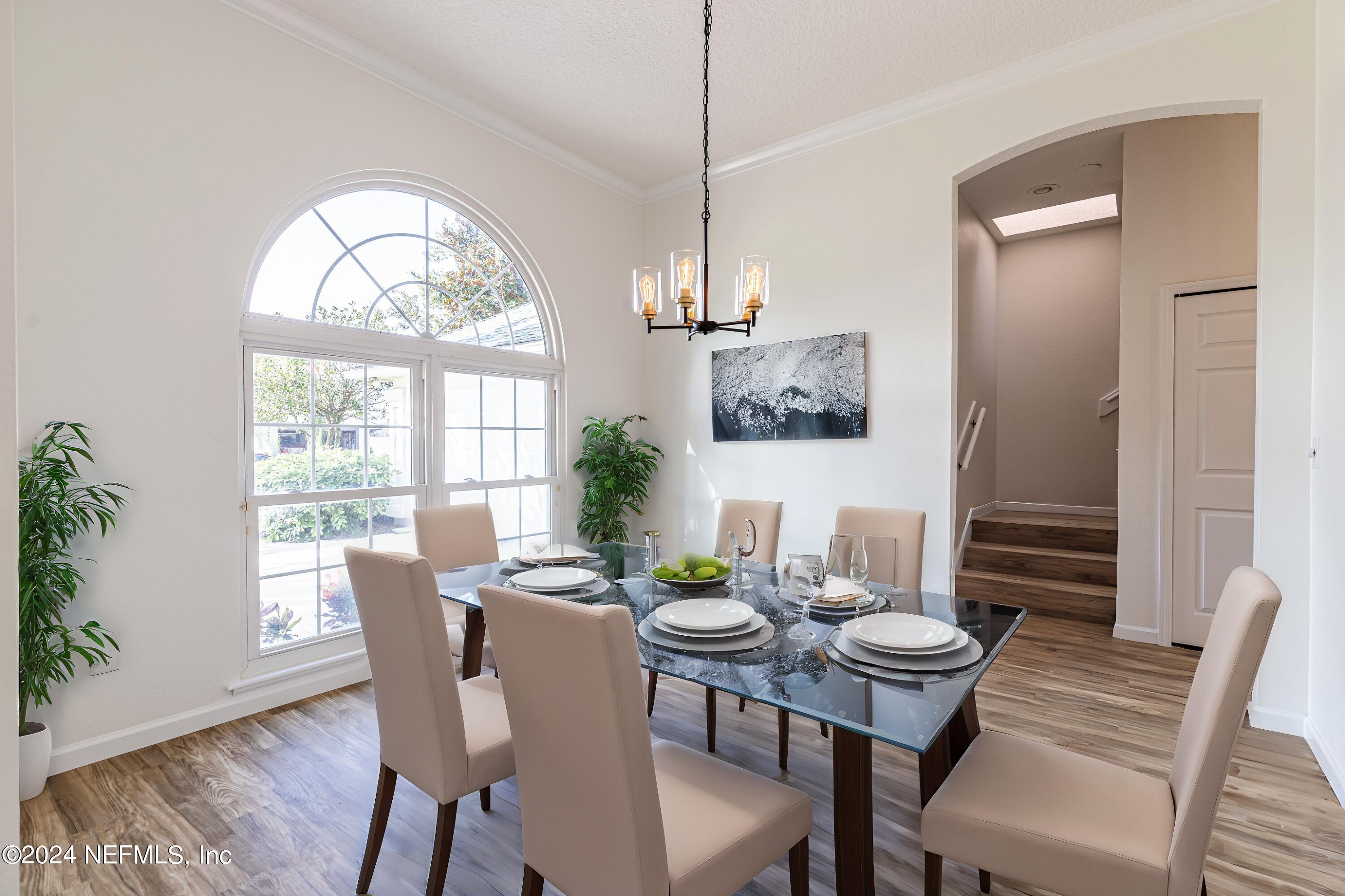 156 Bilbao Drive St. Augustine, FL 32086 - Photo 10 of 57 a view of a dining room with furniture window and wooden floor