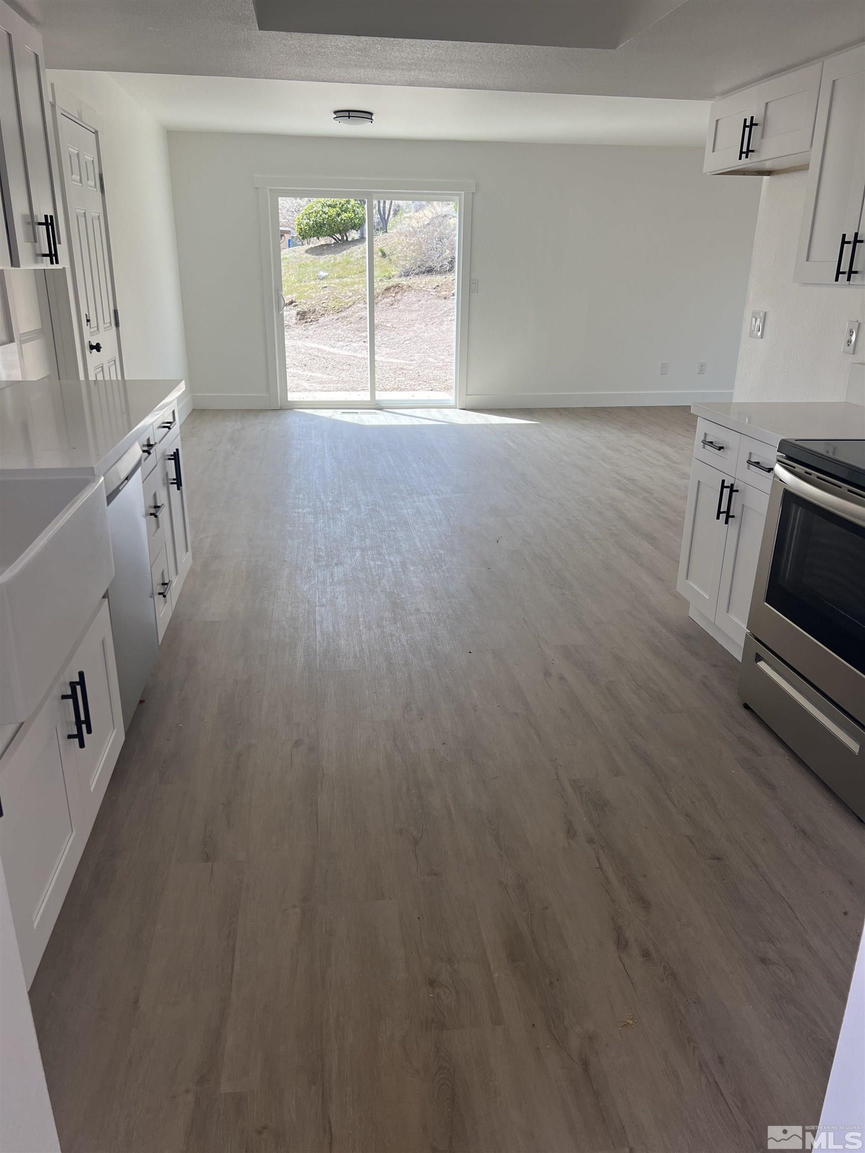 105 Cheyenne Drive Reno, NV 89521 - Photo 5 of 25 a view of empty room with wooden floor and fan