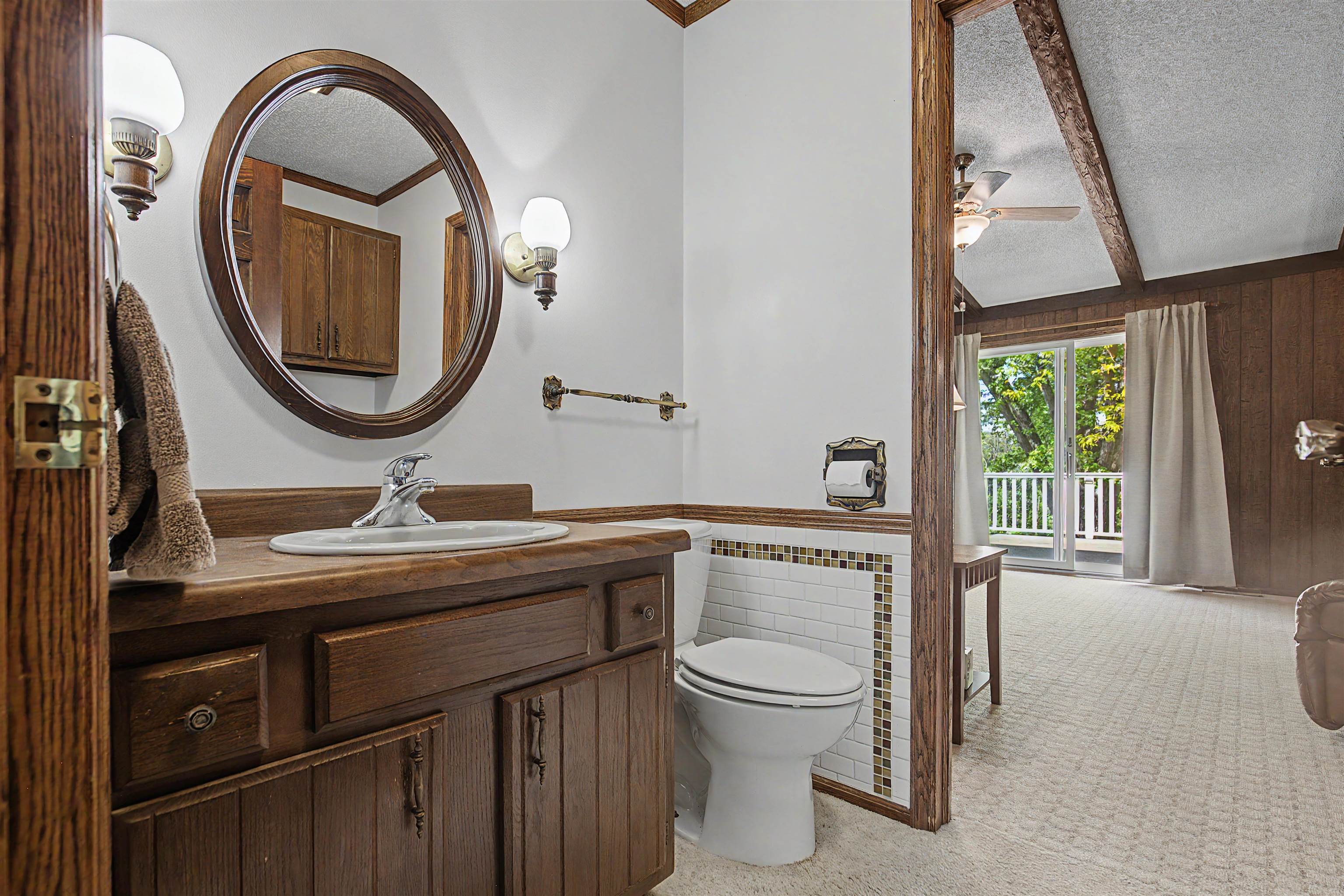 17380 Corbett Road Mount Carroll, IL 61053 - Photo 37 of 65 a bathroom with a toilet a sink and a mirror