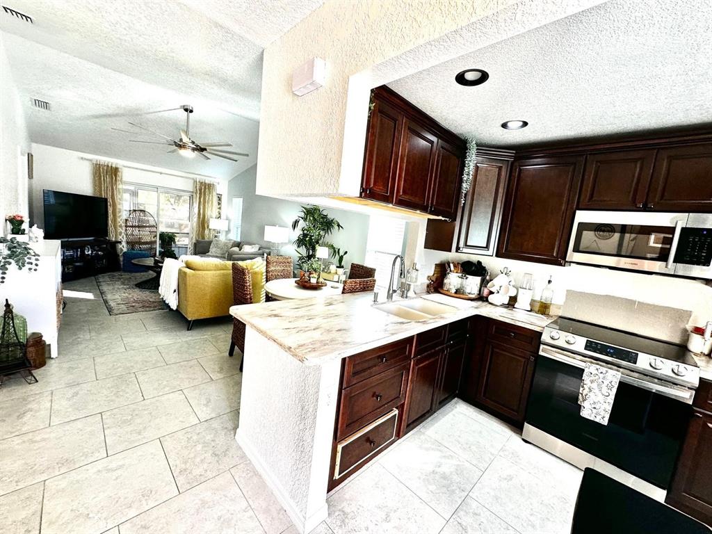 4749 Sunny Loop, Unit 4749 Holiday, FL 34690 - Photo 12 of 34 a kitchen with a sink appliances and cabinets