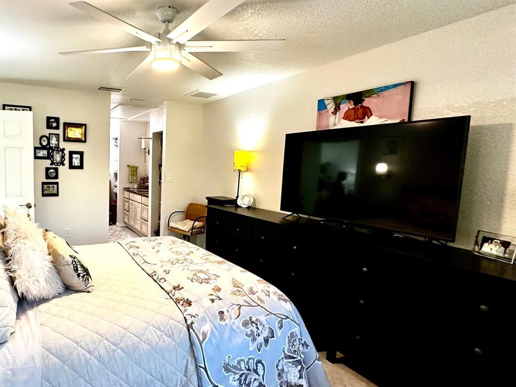 4749 Sunny Loop, Unit 4749 Holiday, FL 34690 - Photo 15 of 34 a bedroom with a bed and a flat screen tv