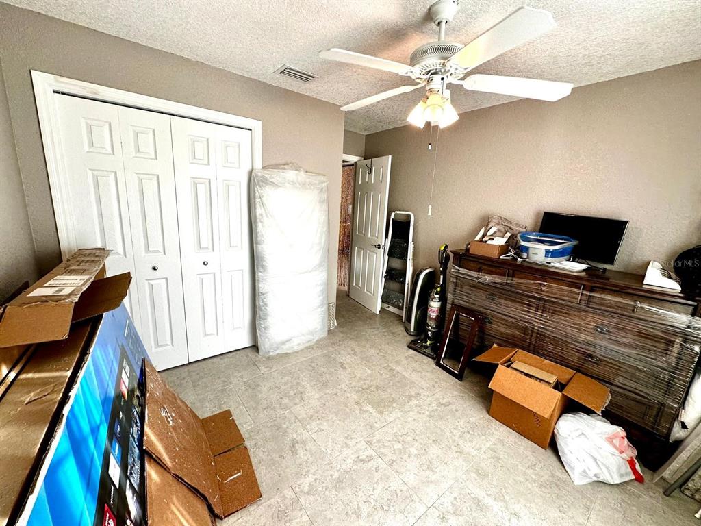 4749 Sunny Loop, Unit 4749 Holiday, FL 34690 - Photo 20 of 34 a living room with furniture and a flat screen tv