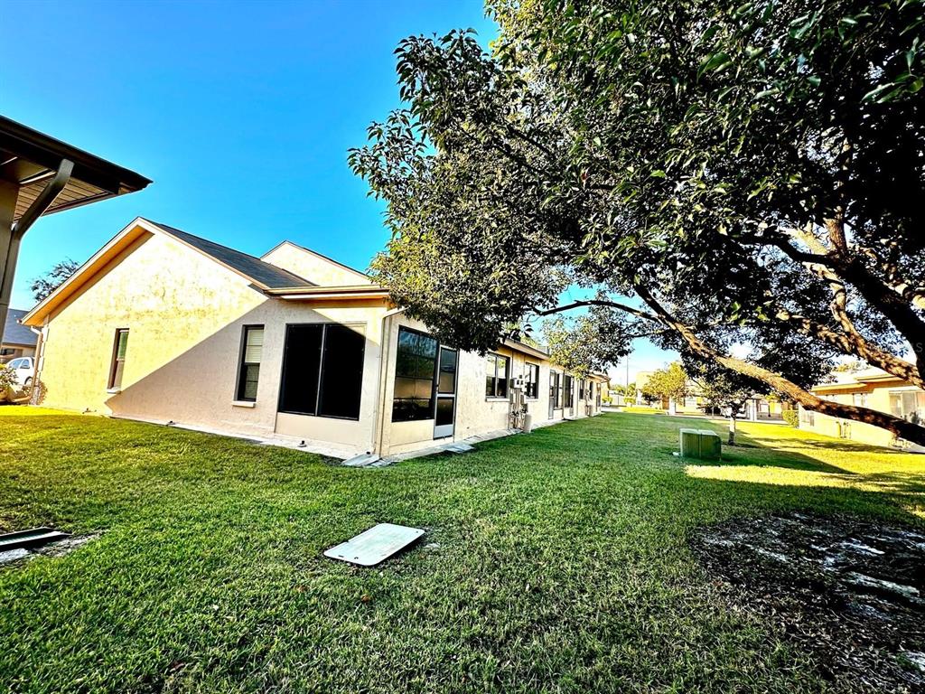 4749 Sunny Loop, Unit 4749 Holiday, FL 34690 - Photo 30 of 34 a view of a house with a yard