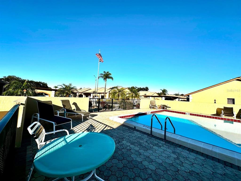 4749 Sunny Loop, Unit 4749 Holiday, FL 34690 - Photo 33 of 34 a view of a swimming pool with an outdoor seating