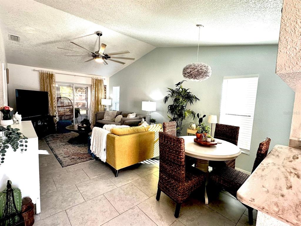 4749 Sunny Loop, Unit 4749 Holiday, FL 34690 - Photo 4 of 34 a living room with furniture a flat screen tv and kitchen view