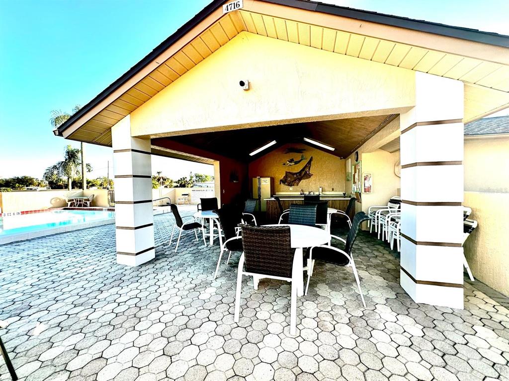 4749 Sunny Loop, Unit 4749 Holiday, FL 34690 - Photo 7 of 34 a dining room with furniture and a floor to ceiling window