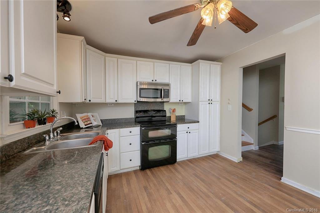 3327 Woodleaf Road Charlotte, NC 28205 - Photo 12 of 36 a kitchen with stainless steel appliances granite countertop a sink a stove top oven a counter space and cabinets