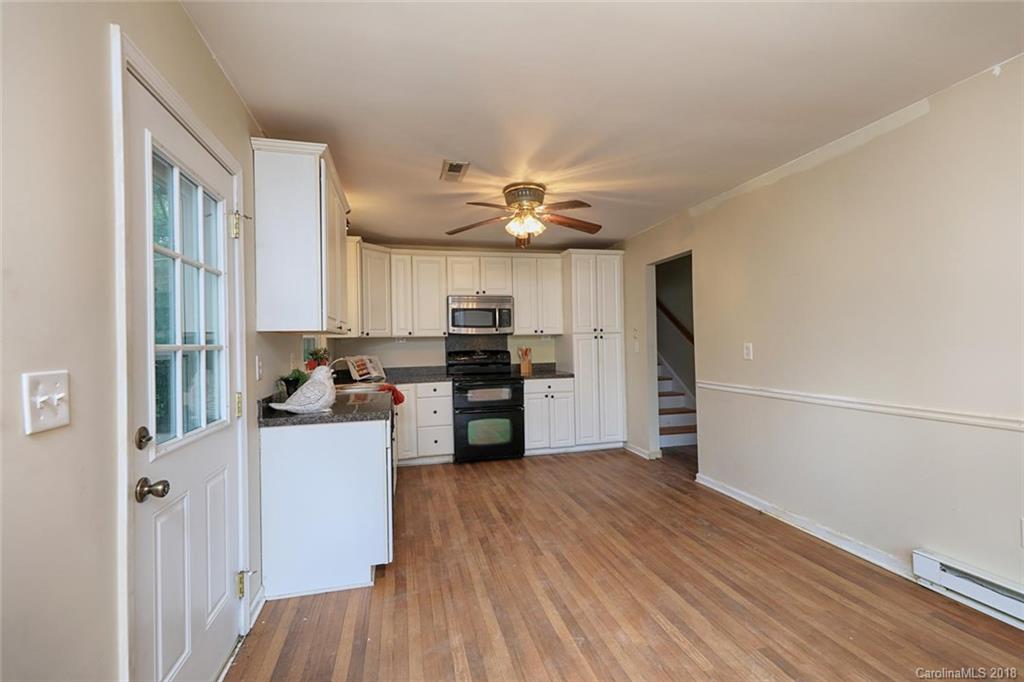 3327 Woodleaf Road Charlotte, NC 28205 - Photo 13 of 36 a kitchen with stainless steel appliances a refrigerator and a stove top oven
