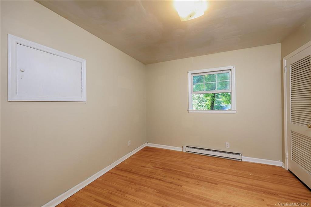 3327 Woodleaf Road Charlotte, NC 28205 - Photo 15 of 36 an empty room with wooden floor and windows