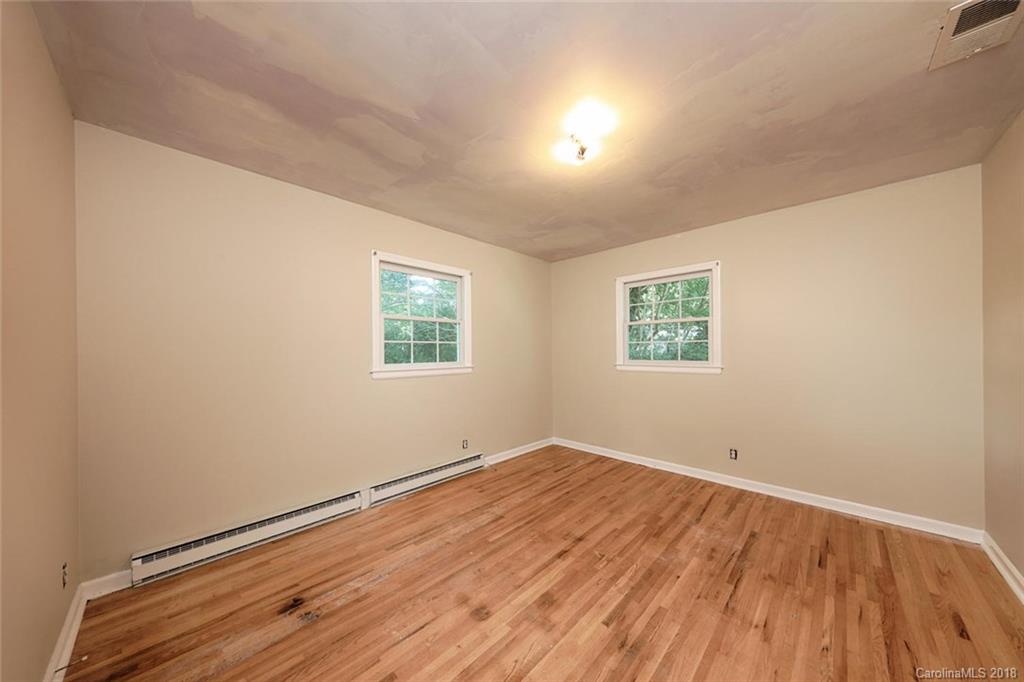 3327 Woodleaf Road Charlotte, NC 28205 - Photo 16 of 36 an empty room with wooden floor and windows