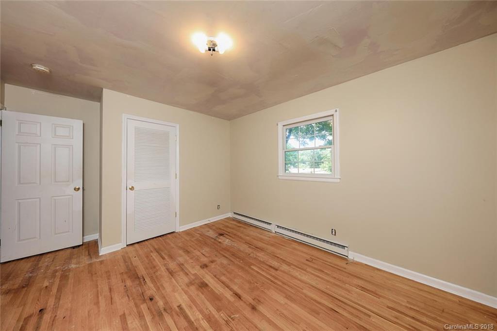 3327 Woodleaf Road Charlotte, NC 28205 - Photo 17 of 36 an empty room with wooden floor and windows