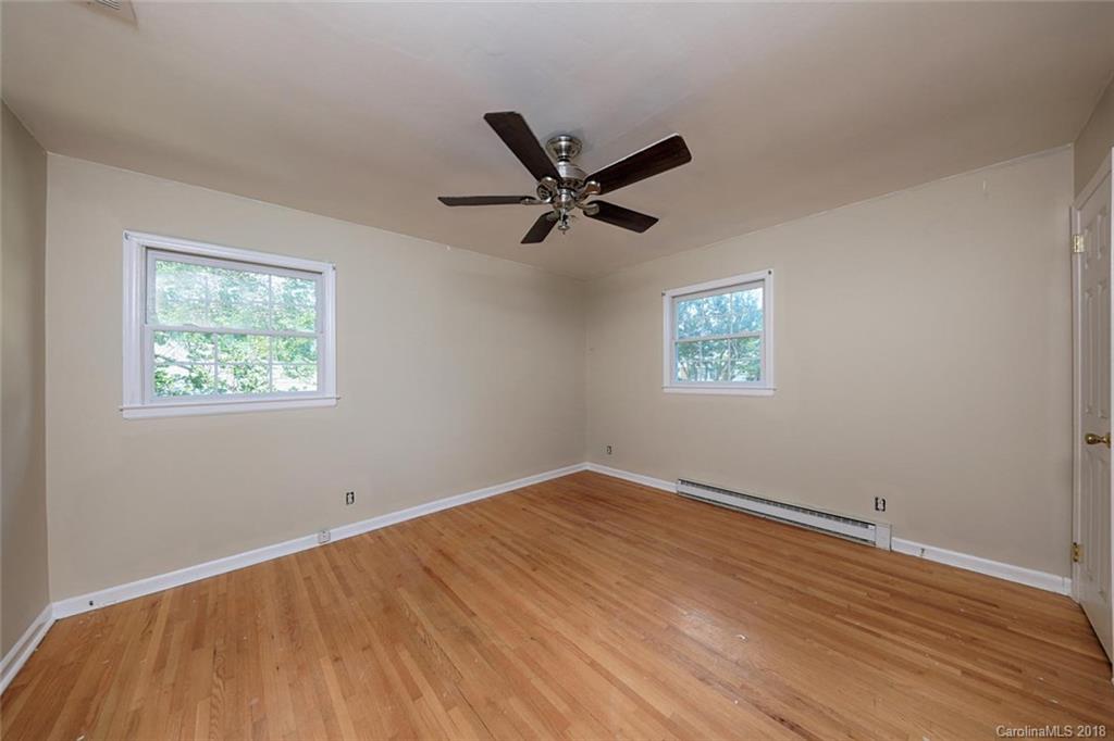 3327 Woodleaf Road Charlotte, NC 28205 - Photo 18 of 36 wooden floor in an empty room with a window