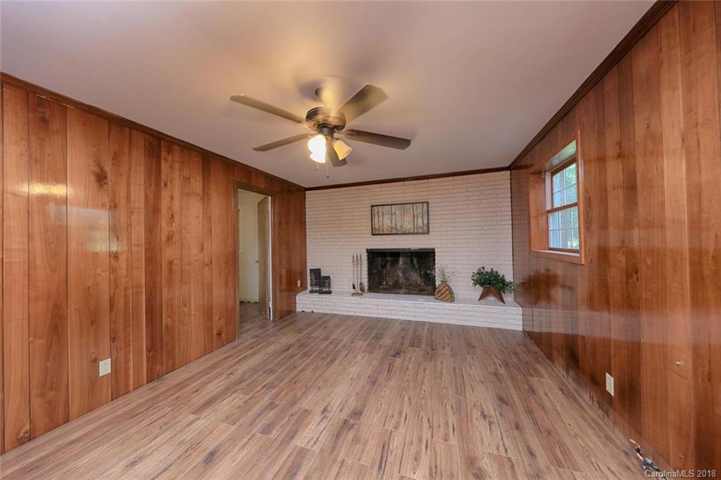 3327 Woodleaf Road Charlotte, NC 28205 - Photo 21 of 36 wooden floor in an empty room with a fireplace