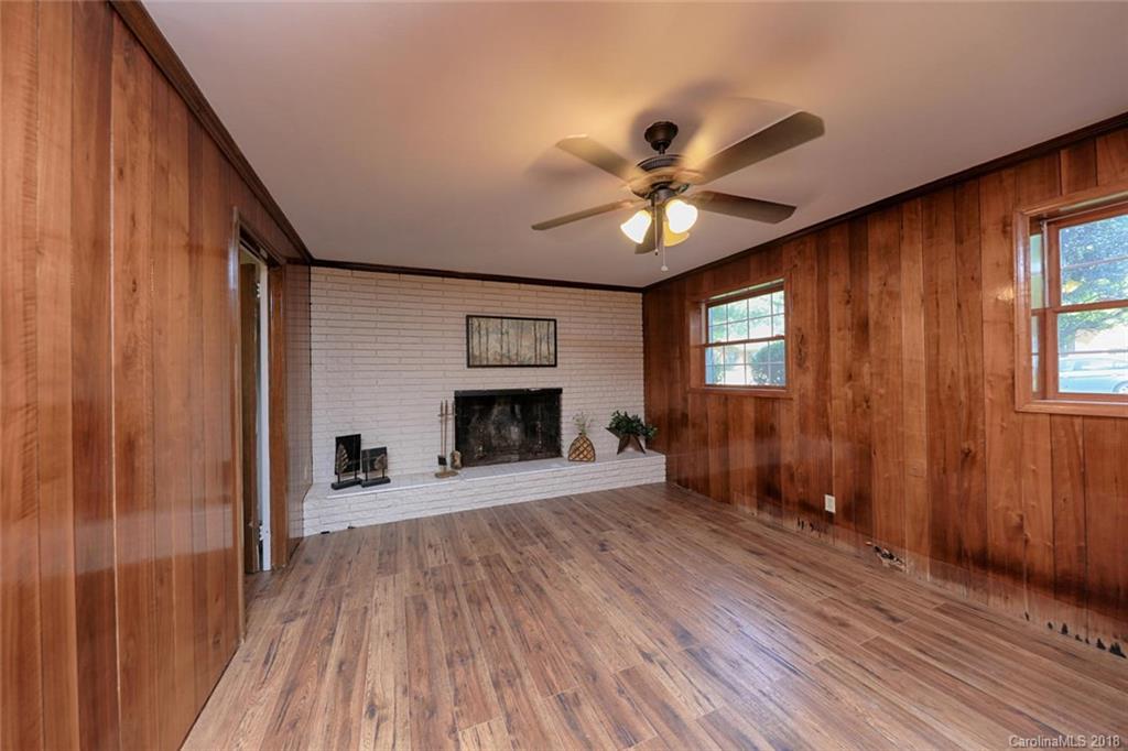 3327 Woodleaf Road Charlotte, NC 28205 - Photo 22 of 36 wooden floor in an empty room with a fireplace