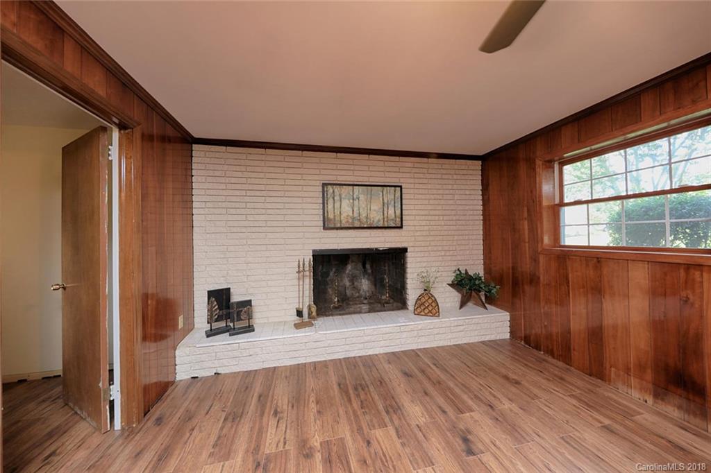 3327 Woodleaf Road Charlotte, NC 28205 - Photo 23 of 36 a view of a livingroom with wooden floor and a fireplace