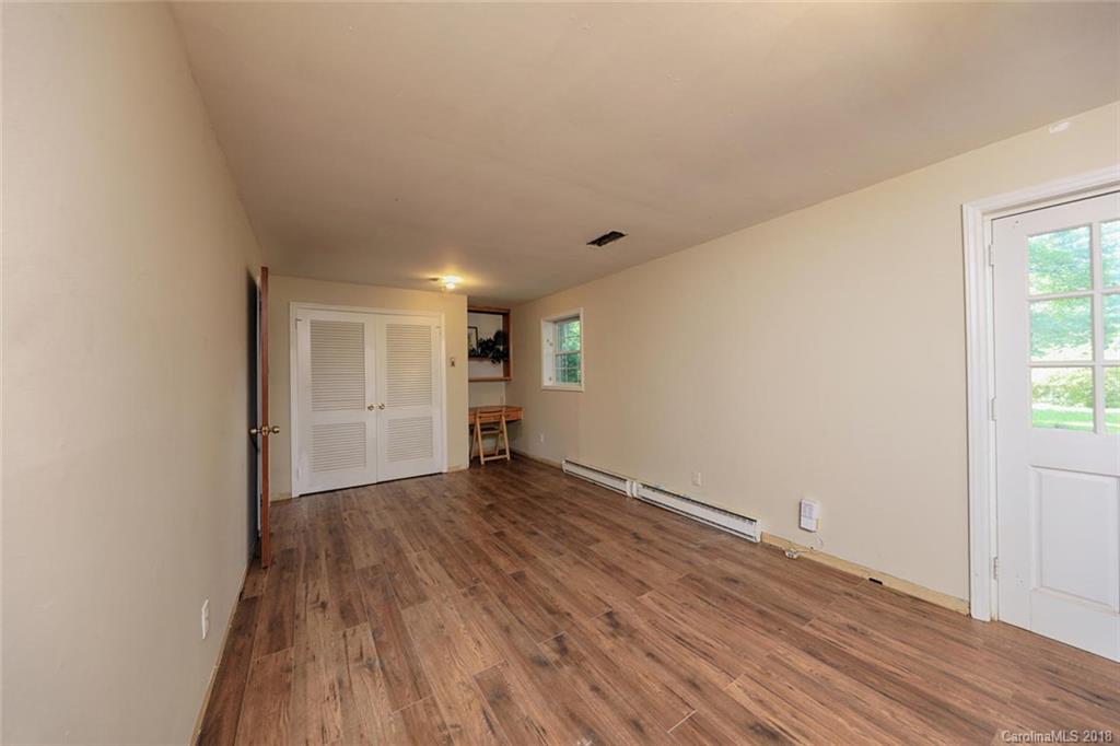 3327 Woodleaf Road Charlotte, NC 28205 - Photo 24 of 36 an empty room with wooden floor and windows