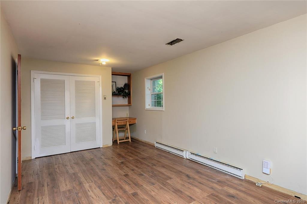 3327 Woodleaf Road Charlotte, NC 28205 - Photo 25 of 36 a view of empty room with wooden floor and cabinet