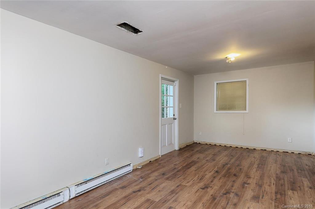 3327 Woodleaf Road Charlotte, NC 28205 - Photo 26 of 36 an empty room with wooden floor and windows