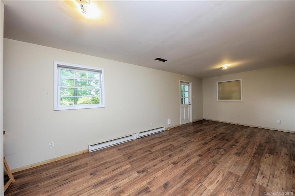 3327 Woodleaf Road Charlotte, NC 28205 - Photo 27 of 36 a view of an empty room with wooden floor and a window