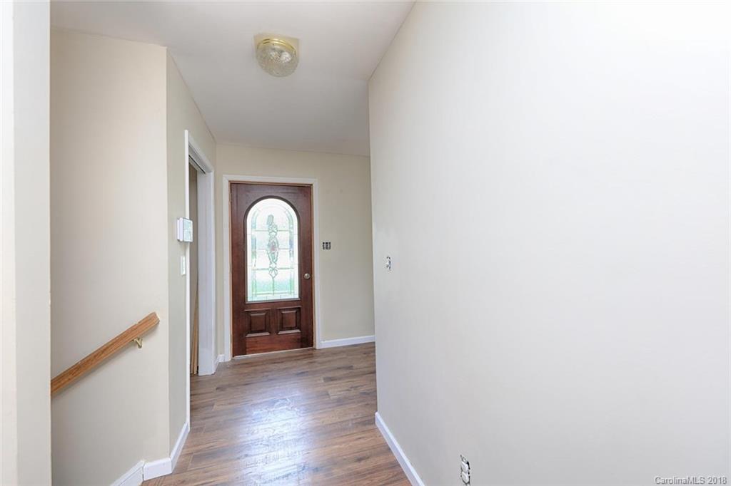 3327 Woodleaf Road Charlotte, NC 28205 - Photo 4 of 36 a view of a hallway with wooden floor and front door