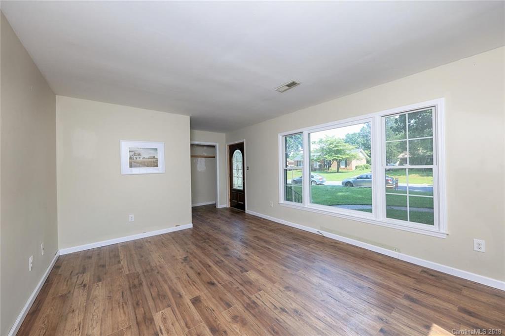 3327 Woodleaf Road Charlotte, NC 28205 - Photo 6 of 36 an empty room with wooden floor and windows