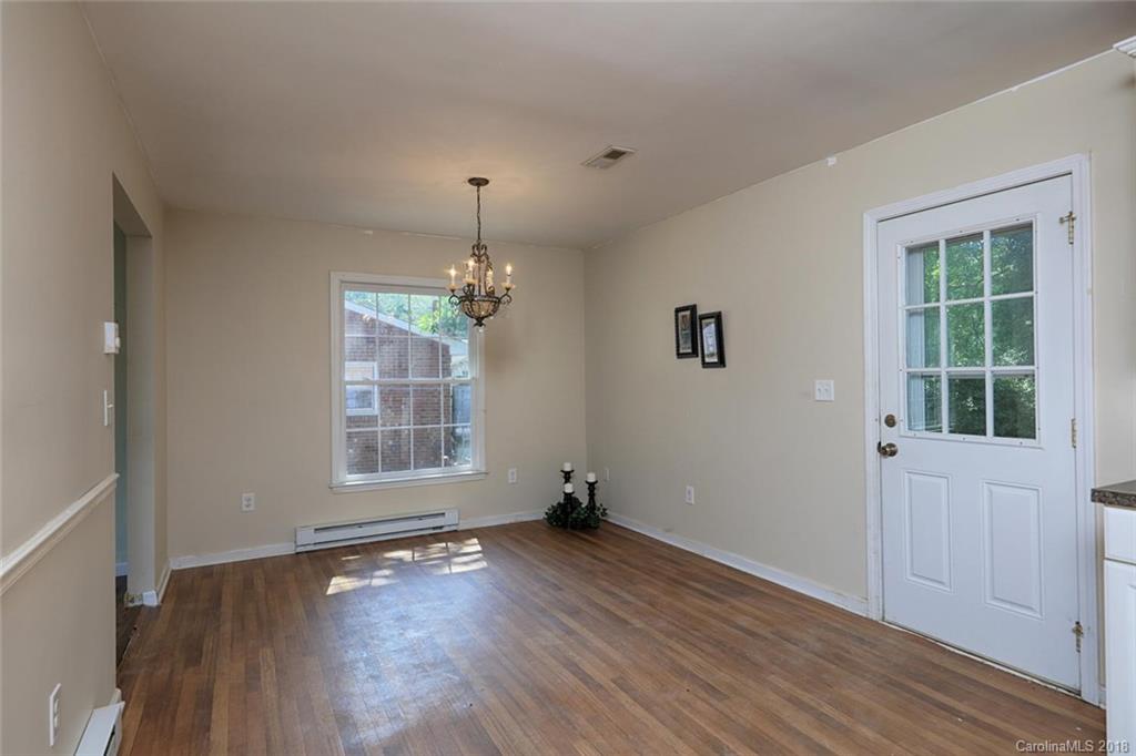 3327 Woodleaf Road Charlotte, NC 28205 - Photo 7 of 36 an empty room with wooden floor and windows