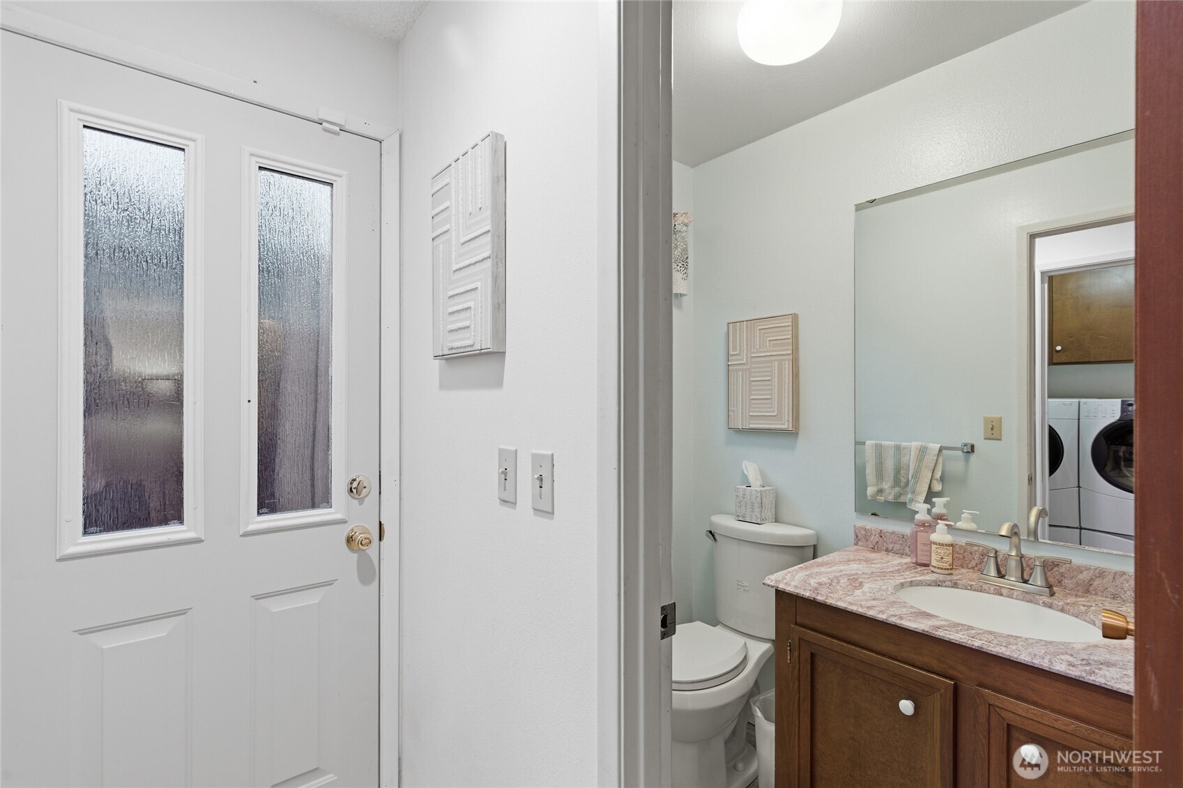 14523 Southeast 167th Street Renton, WA 98058 - Photo 29 of 39 a bathroom with a granite countertop sink toilet and mirror