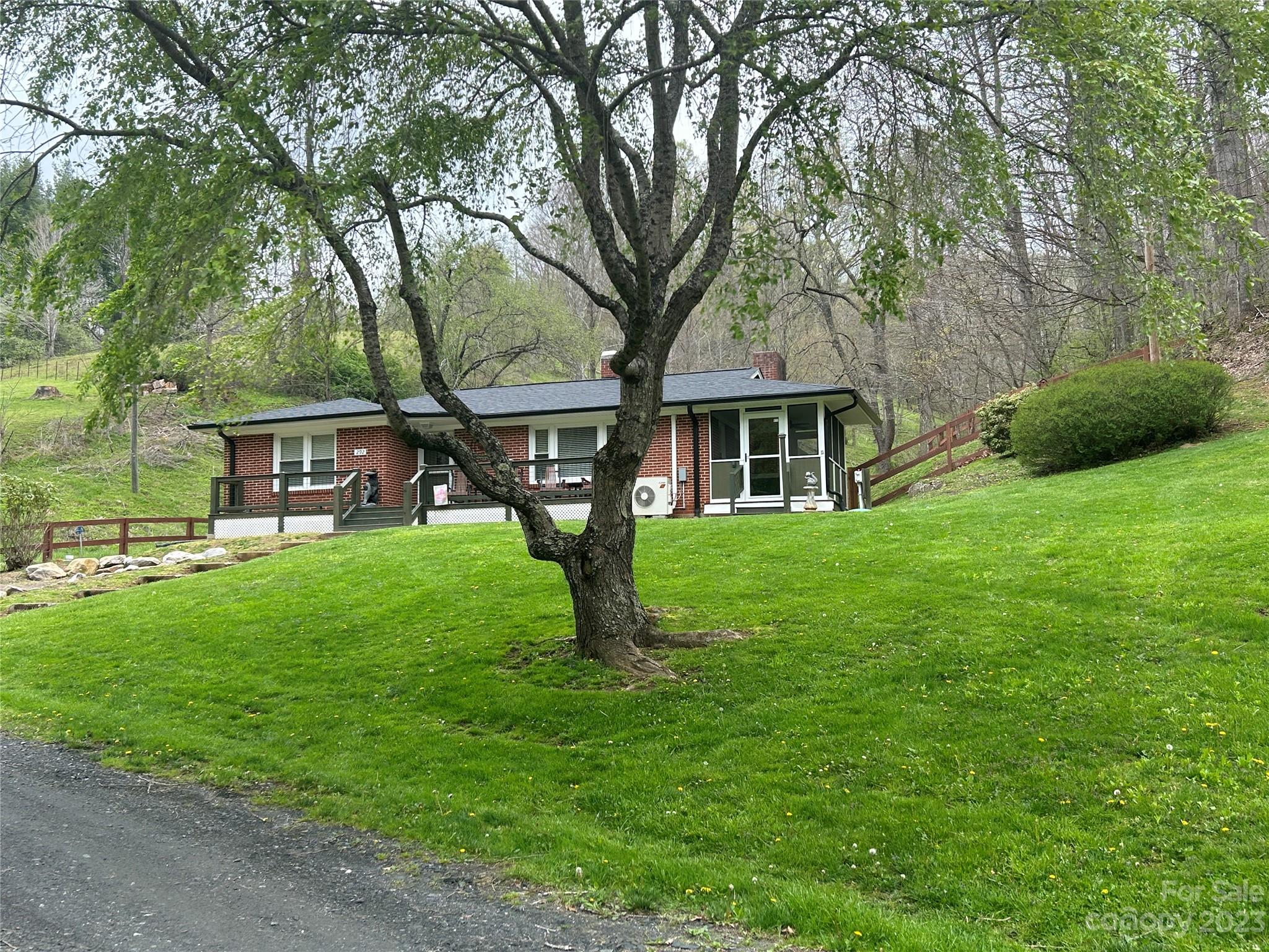 292 Welch Road Lansing, NC 28643 - Photo 1 of 47 a front view of a house with garden