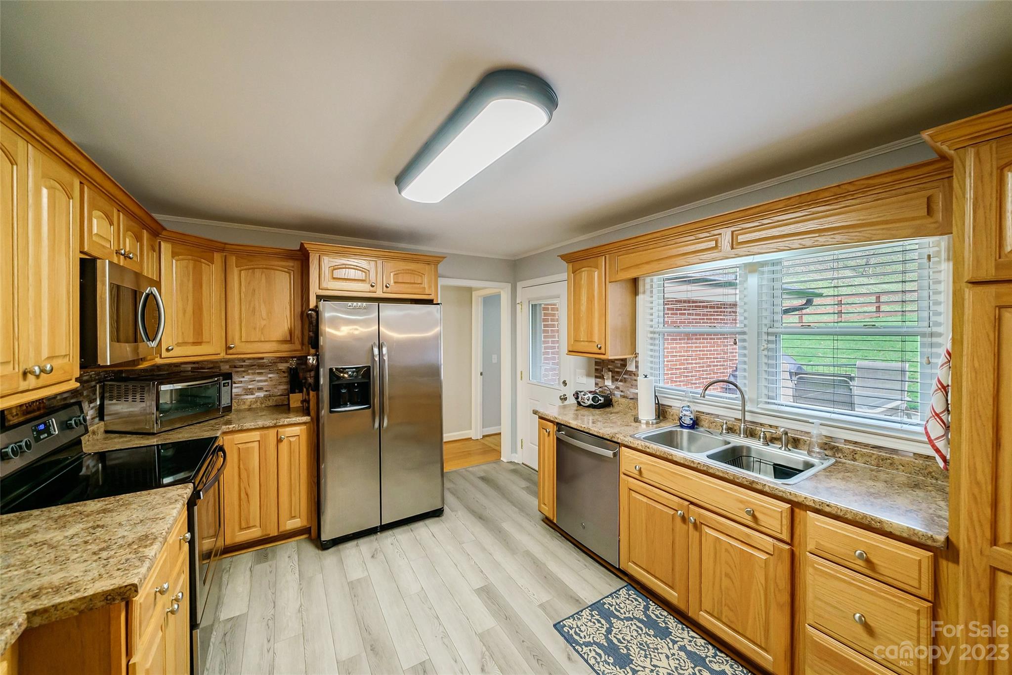 292 Welch Road Lansing, NC 28643 - Photo 11 of 47 a kitchen with stainless steel appliances granite countertop a sink stove and refrigerator
