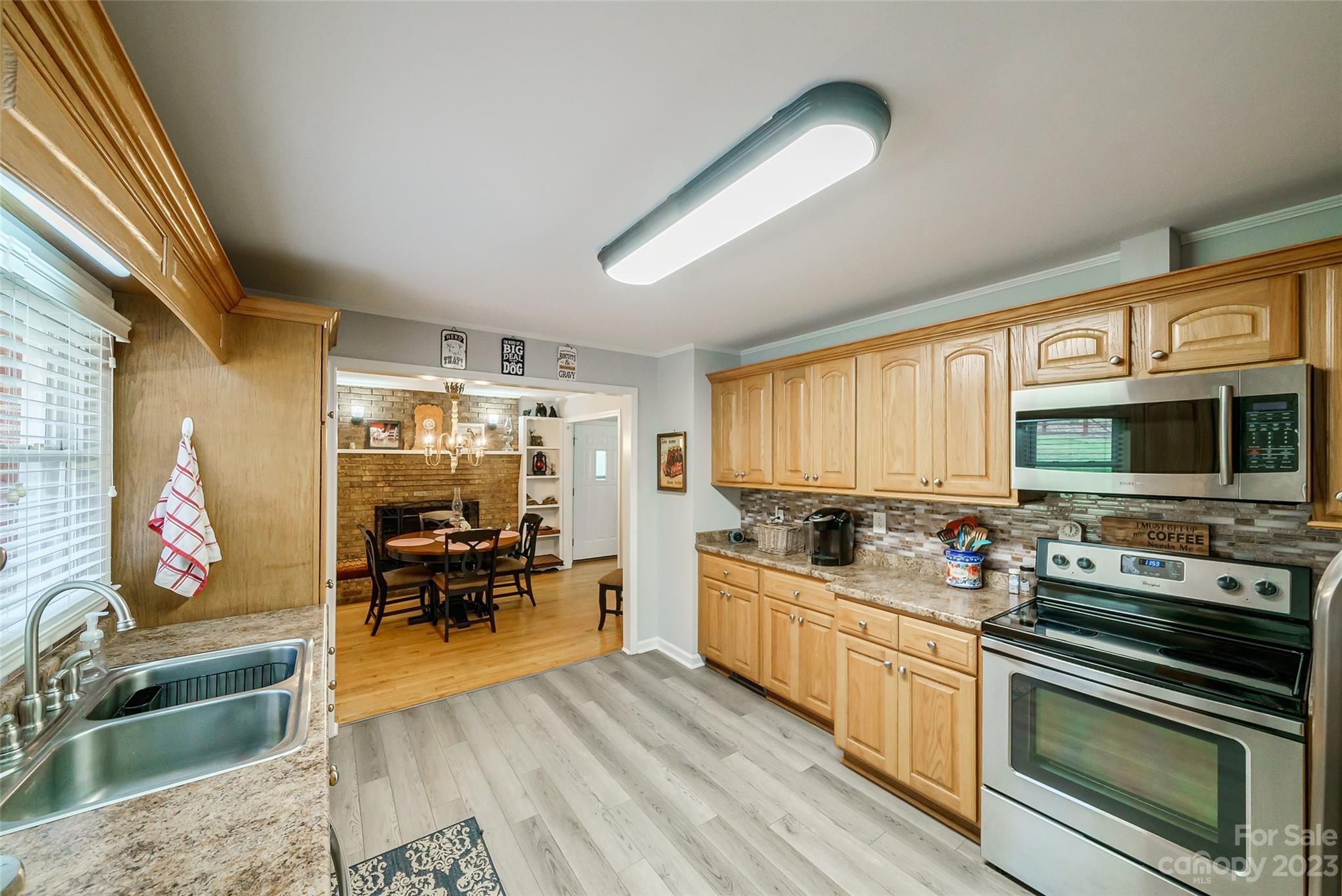292 Welch Road Lansing, NC 28643 - Photo 14 of 47 a kitchen with stainless steel appliances kitchen island granite countertop a stove a sink and a microwave