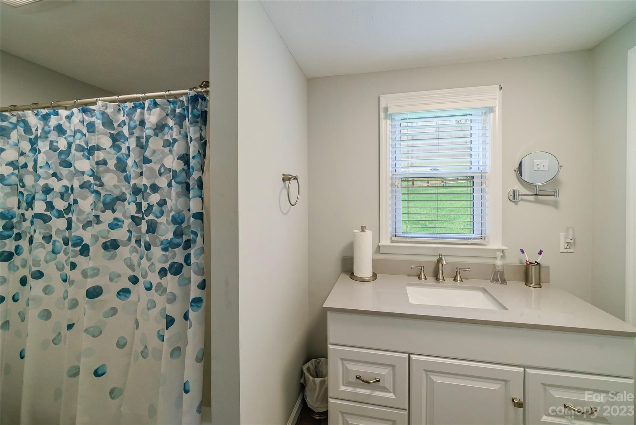 292 Welch Road Lansing, NC 28643 - Photo 19 of 47 a bathroom with a sink a vanity and a mirror