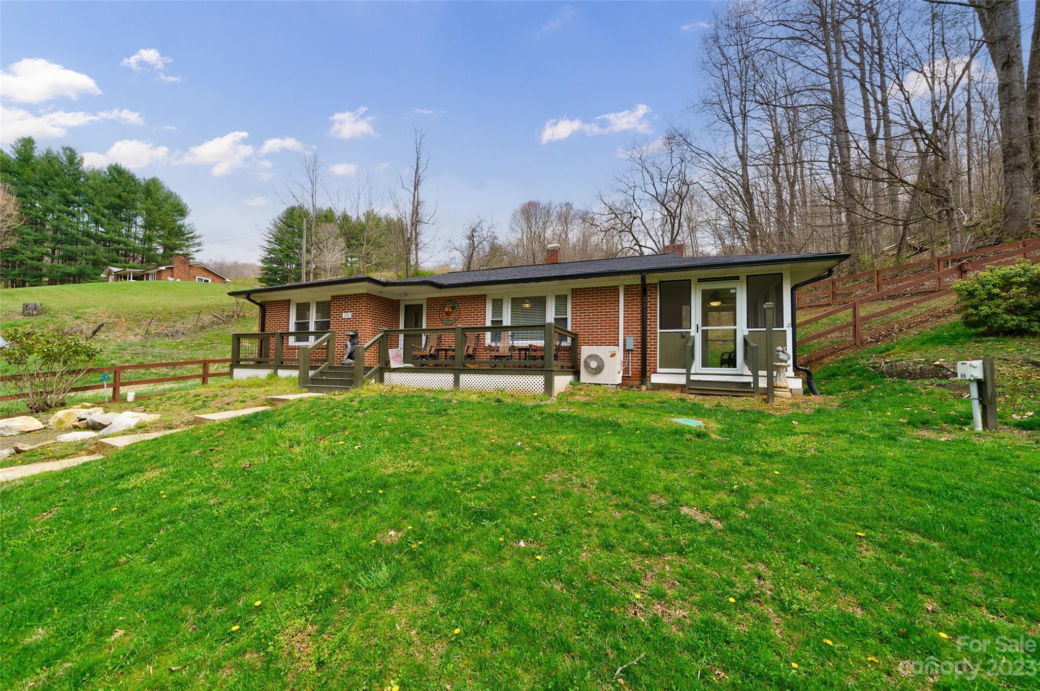 292 Welch Road Lansing, NC 28643 - Photo 2 of 47 a view of a house with a yard and a patio