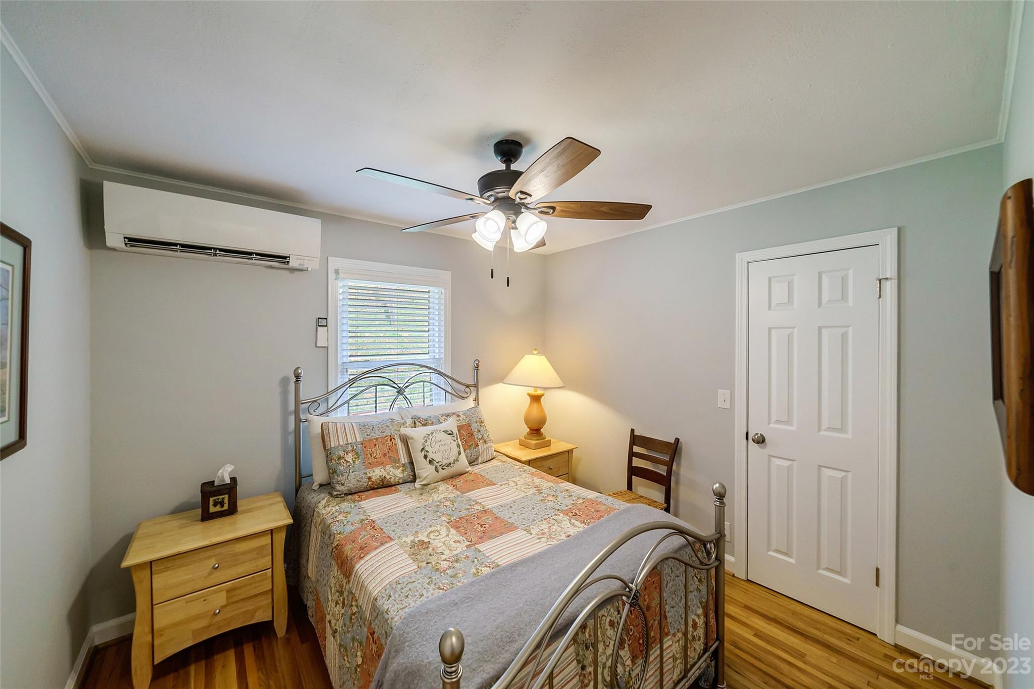 292 Welch Road Lansing, NC 28643 - Photo 21 of 47 a bedroom with a bed and a chandelier