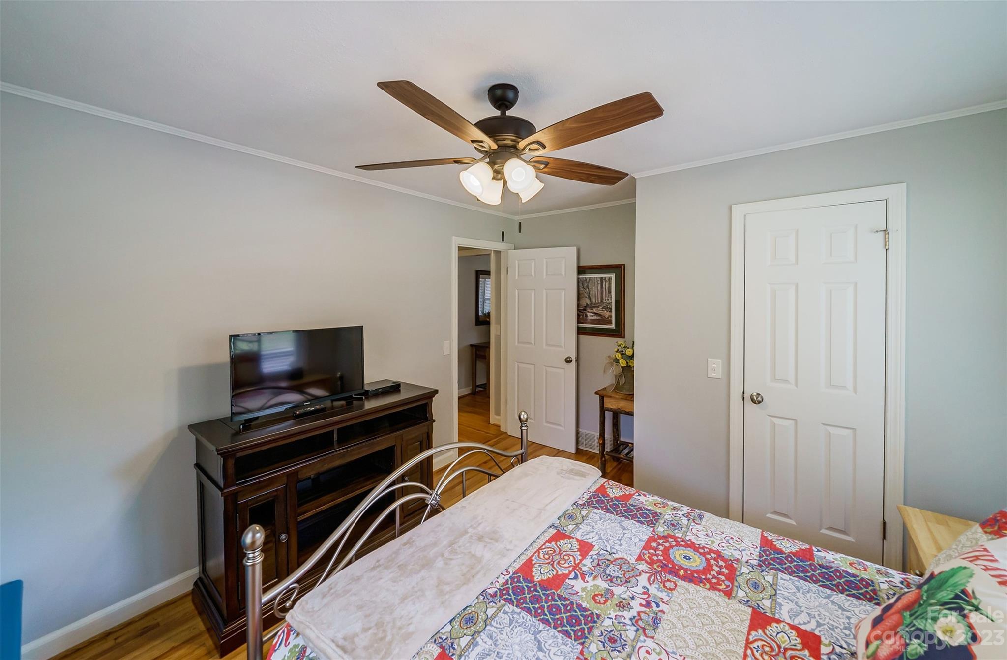 292 Welch Road Lansing, NC 28643 - Photo 24 of 47 a bedroom with a bed and a chandelier