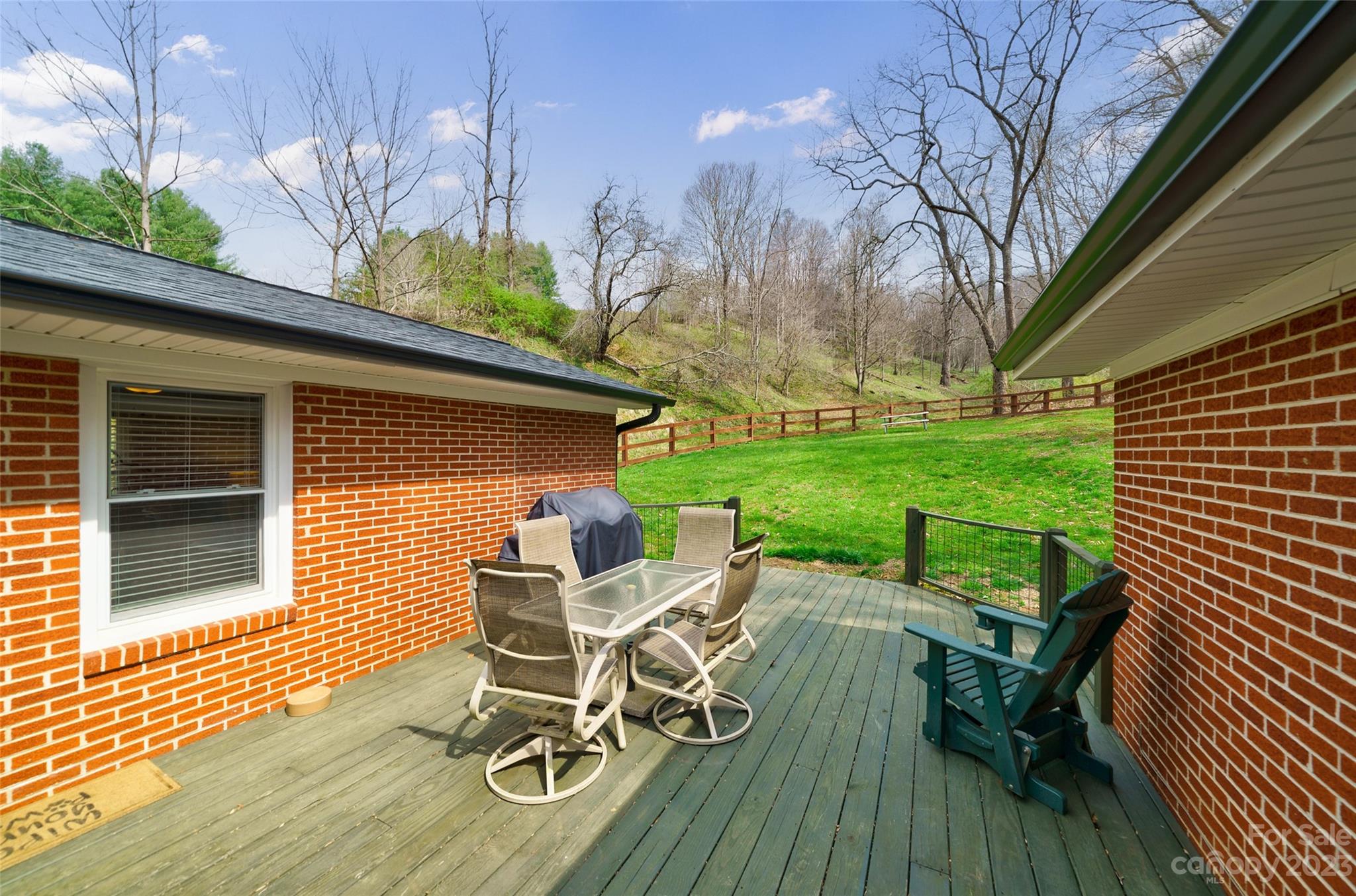 292 Welch Road Lansing, NC 28643 - Photo 29 of 47 a view of a chairs and table in patio with wooden fence