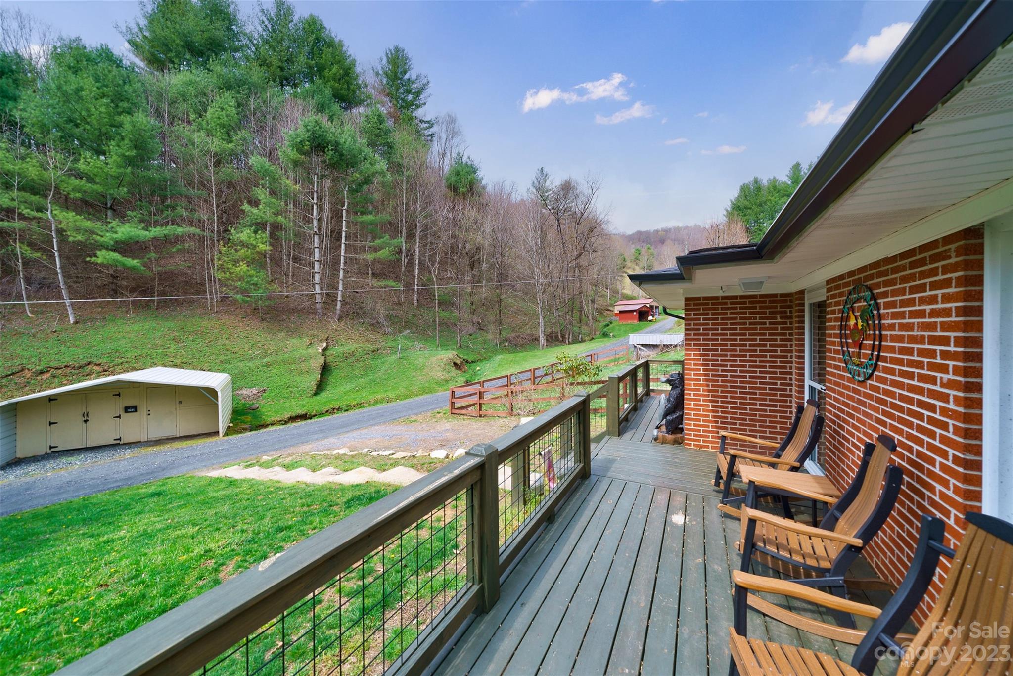 292 Welch Road Lansing, NC 28643 - Photo 3 of 47 a view of a chair and table on the wooden deck