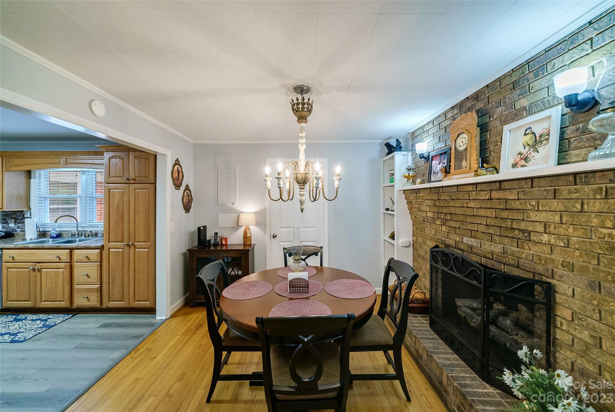 292 Welch Road Lansing, NC 28643 - Photo 8 of 47 a dining room with furniture a chandelier and wooden floor