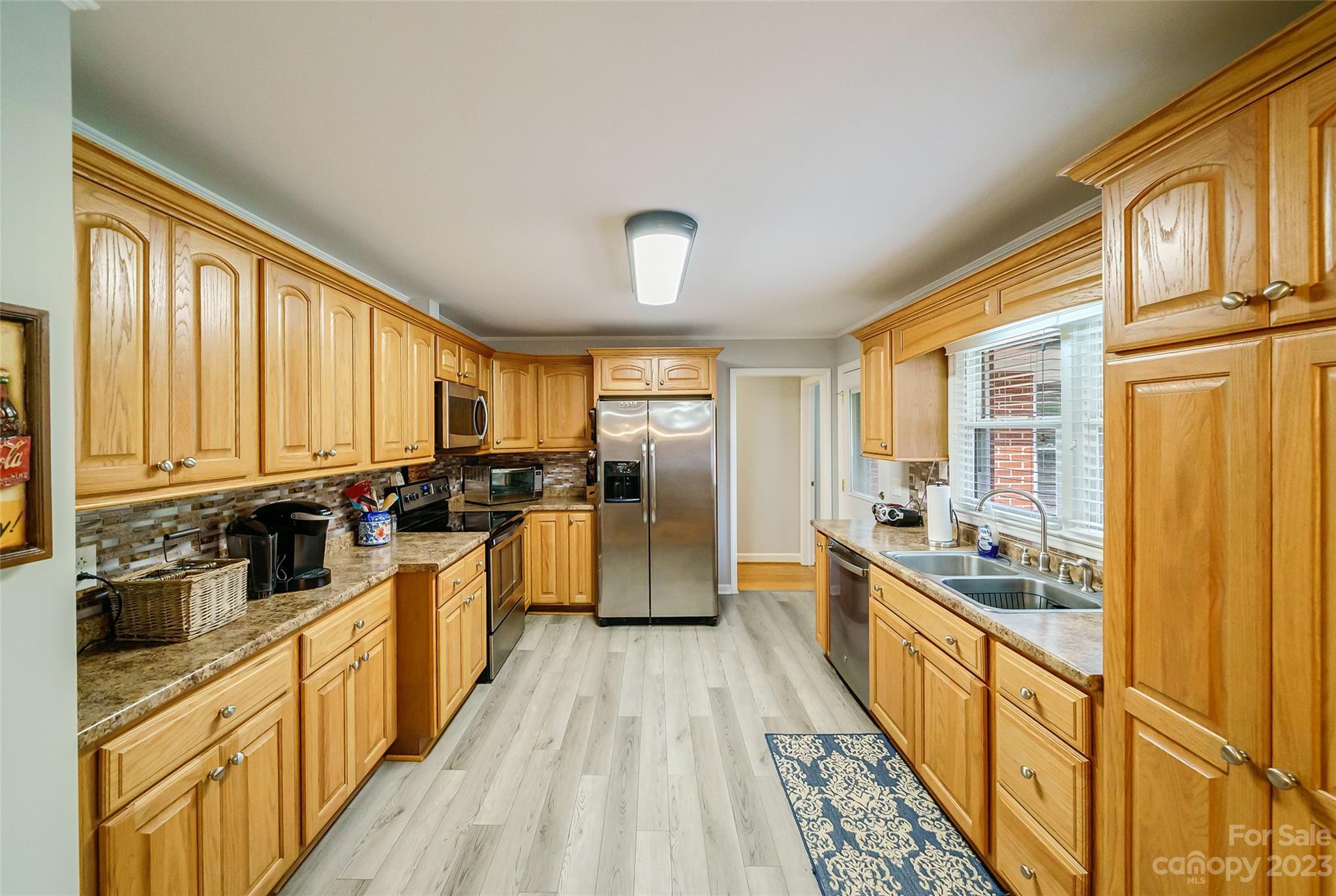 292 Welch Road Lansing, NC 28643 - Photo 10 of 47 a view of a kitchen with stainless steel appliances granite countertop lots of counter top space and wooden floor