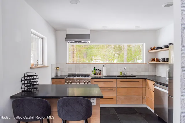 a kitchen with kitchen island a sink stove and refrigerator
