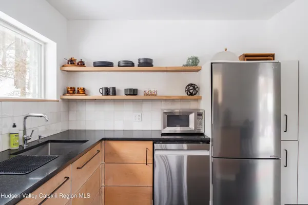 a view of a room with a table and chairs