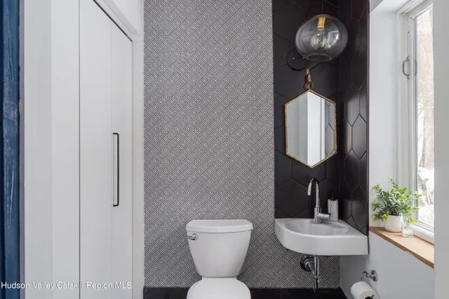 a bathroom with a toilet and a shower curtain