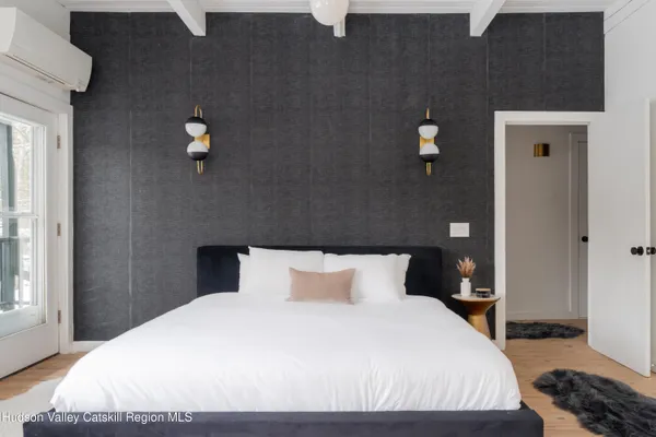 a bedroom with a bed and a couch