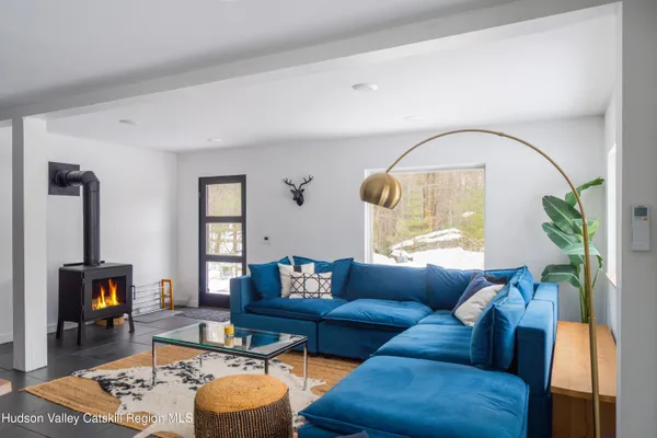 a living room with furniture a rug and a fireplace