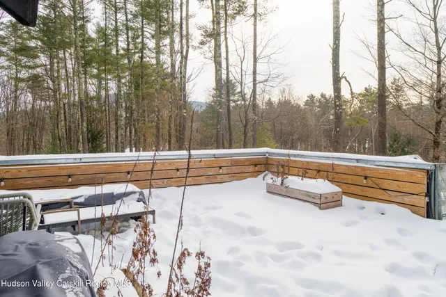a view of a patio with table and chairs and wooden floor