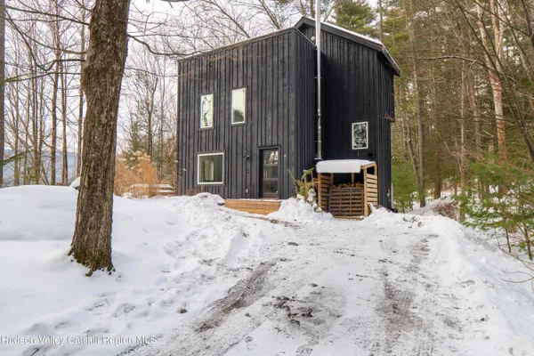 a view of a house with snow on the road