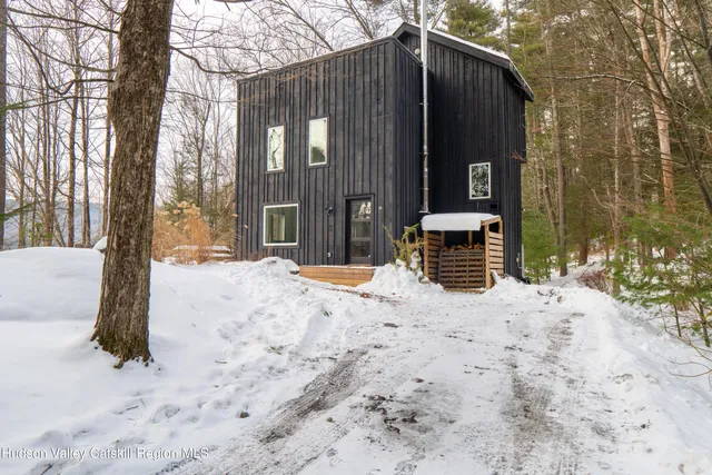 a view of a house with snow on the road