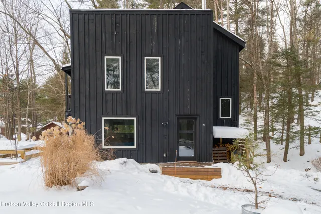 a view of a house with snow on the road