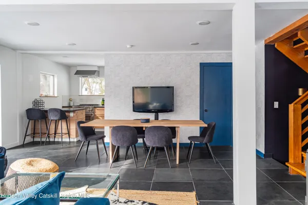 a dining room with furniture and wooden floor